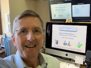 David Thomas sitting at a computer and monitor in his little office